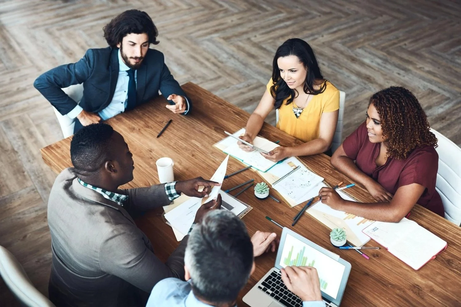 A diverse group of colleagues sharing ideas around a meeting table